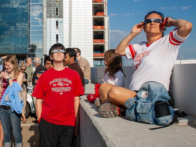 Museum visitors looking at the sun through eclipse glasses for a transit of Venus, 2012.